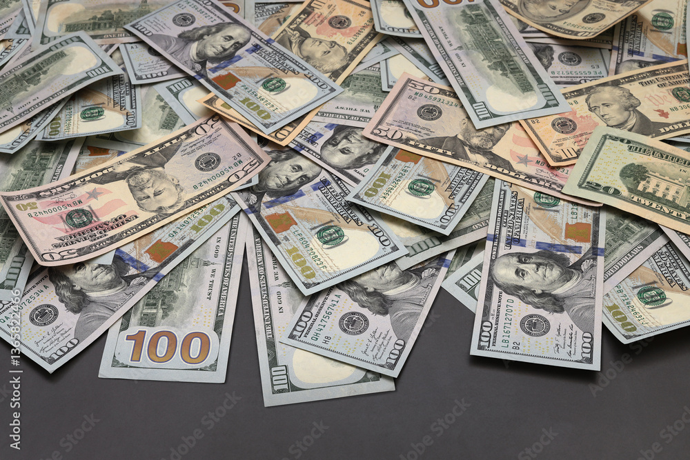 Fototapeta premium Cash hundred dollar banknotes on gray background.