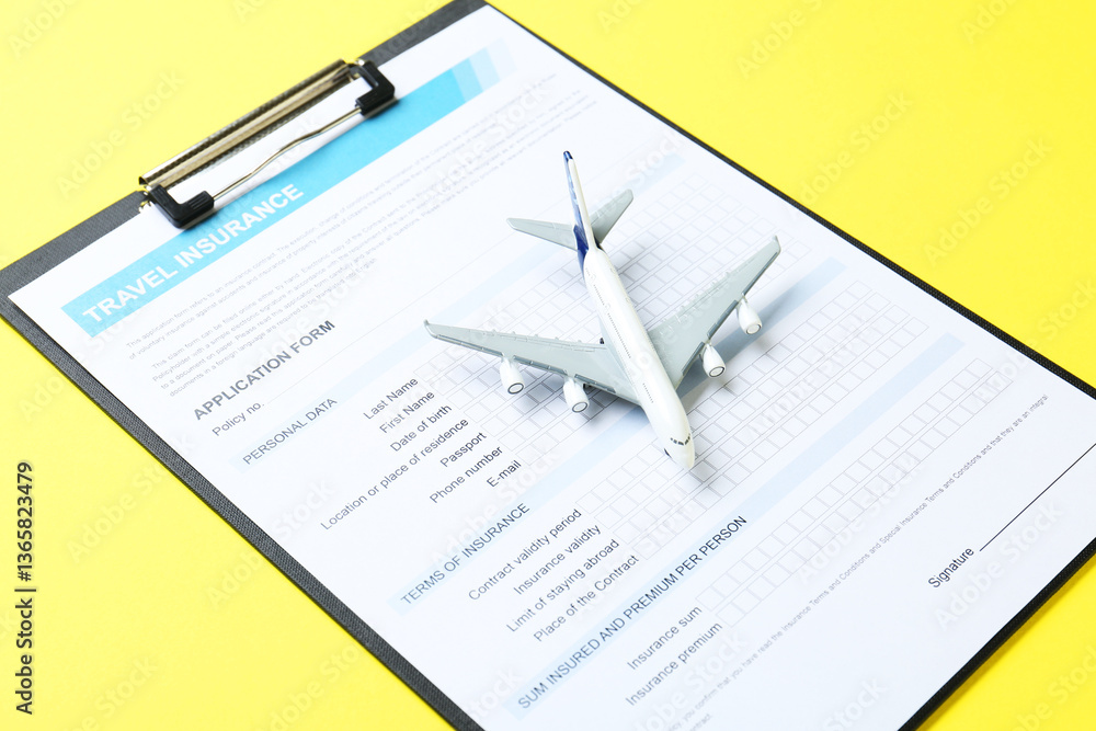 Medical tourism. Travel insurance application form and airplane model on yellow background, closeup Medical tourism. Travel insurance application form and airplane model on yellow background, closeup