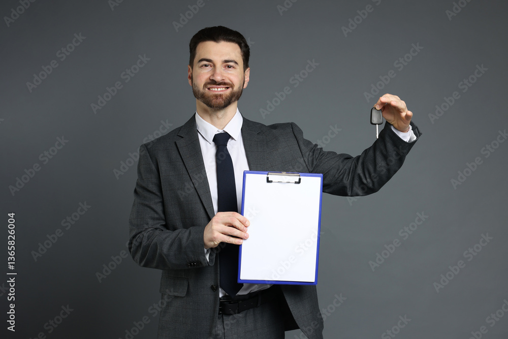 Cheerful salesman with car key and clipboard on grey background Cheerful salesman with car key and clipboard on grey background