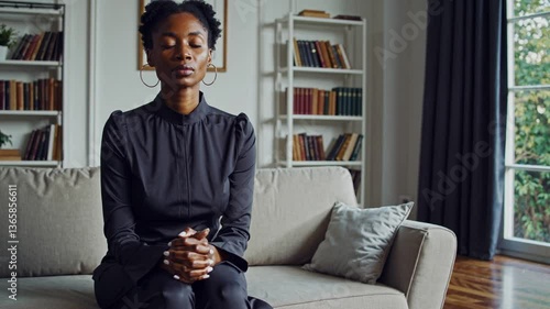 black religious woman in her 30s praying, asking for serenity and peace in Sunday best, uncluttered mind