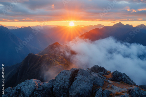 Sun setting over Mount Aspiring summit, with majestic clouds and mountains.