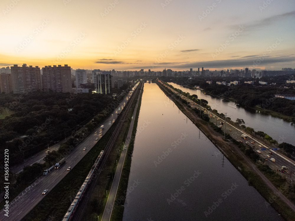 Fototapeta premium Red sunset on grand road next to river