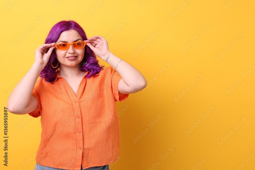 Beautiful woman with bright purple hair on orange background. Space for text Beautiful woman with bright purple hair on orange background. Space for text