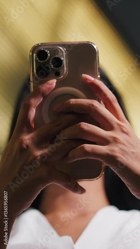 closeup hands of young girl with smart watch touching smartphone screen at night