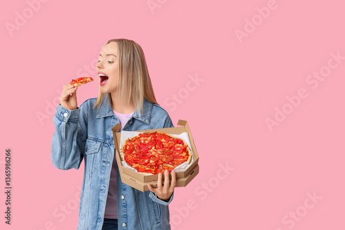 Young woman eating piece of...