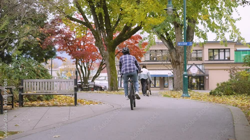 A cyclist cycling in a park in Port Coquitlam. A cyclist cycling in a park in Port Coquitlam.