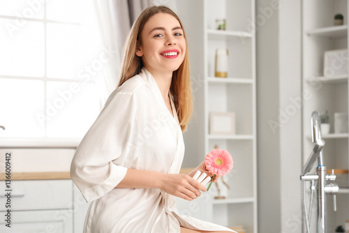 Young woman with flower and...