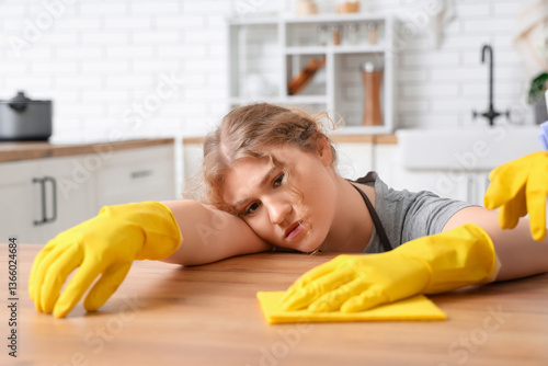 Tired female janitor cleani...