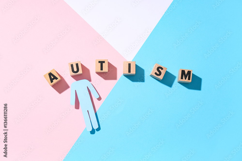Obraz premium Word AUTISM made of wooden cubes and paper human figure on color background