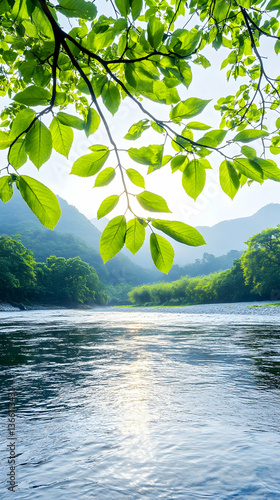 Wallpaper Mural Serene river scene framed by vibrant green leaves, sunlight illuminating the tranquil water and distant mountains Torontodigital.ca