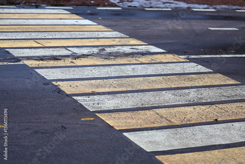 Yellow and white crosswalk on a city street.