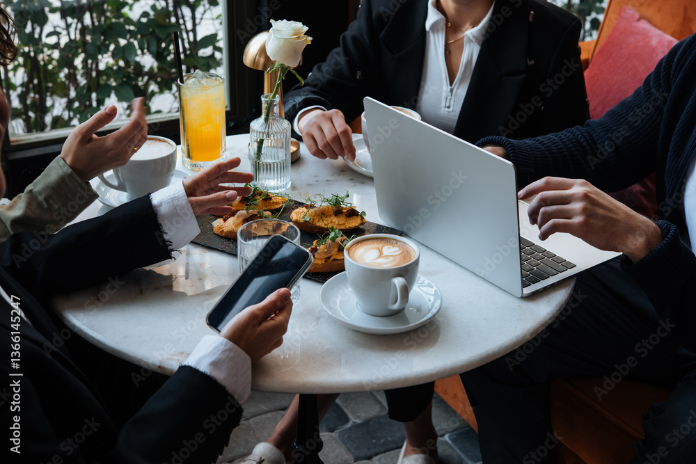 People discussing business projects in a cafe while having coffee.