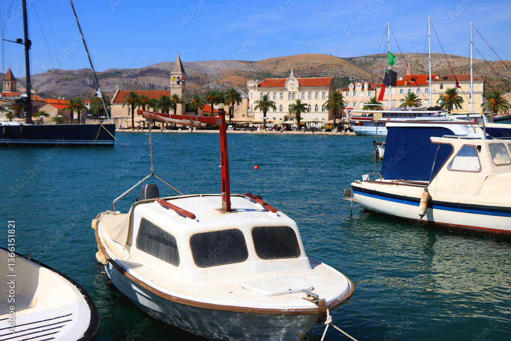Beautiful old buildings, boats and yachts on the promenade in Trogir, Croatia. Sunny summer day in Trogir.