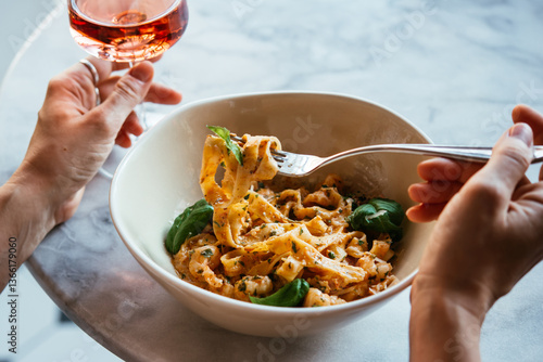Having a pasta dinner at home or in a restaurant.