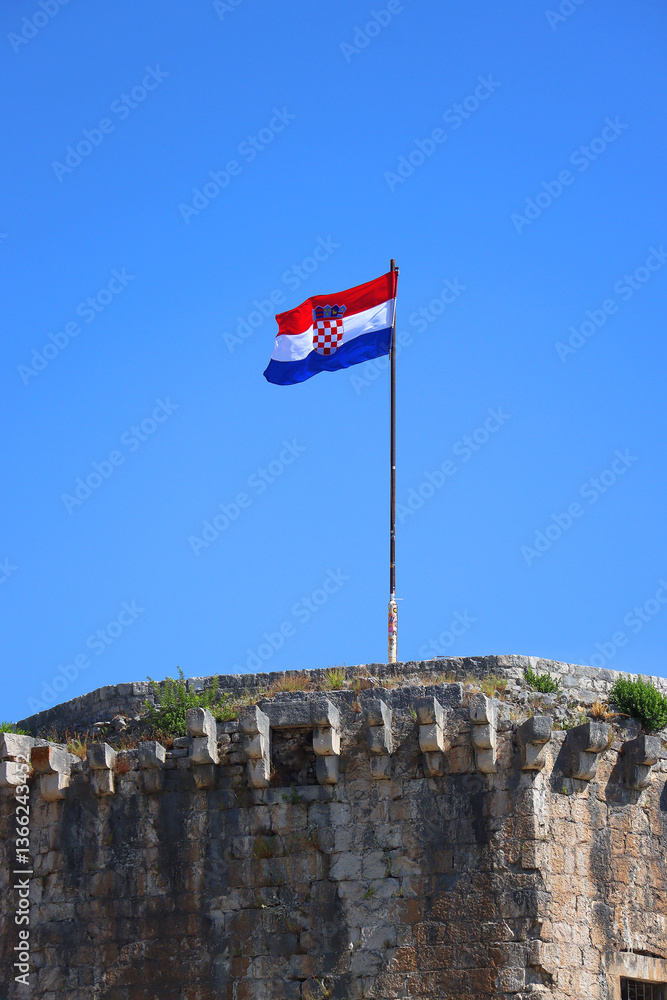 Historical Kamerlengo Fortress in Trogir, Croatia and Croatian flag.