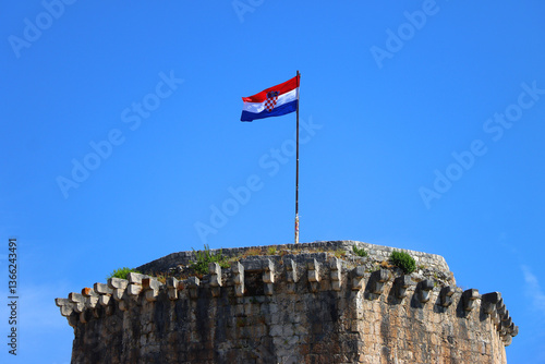 Historical Kamerlengo Fortress in Trogir, Croatia and Croatian flag.
