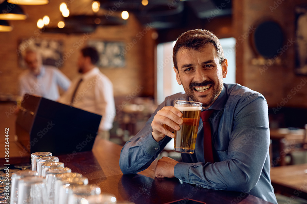 Happy businessman drinking beer in pub and looking at camera. Happy businessman drinking beer in pub and looking at camera.