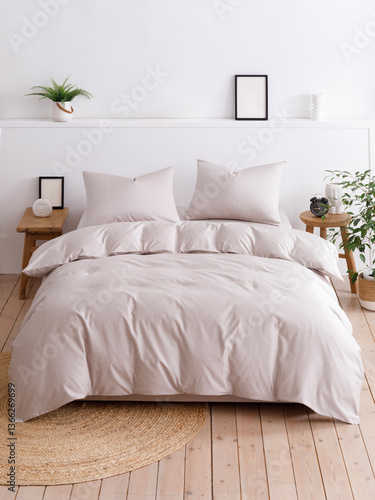 Bedroom with double bed, two pillows and fluffy duvet. Vertical front view photo