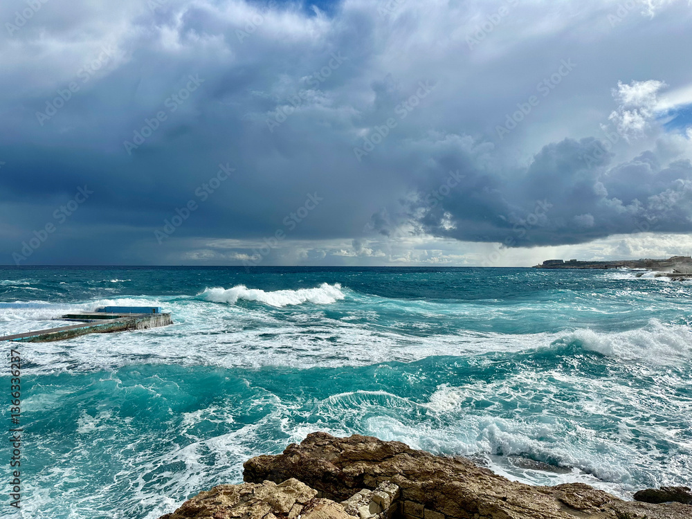 Storm in the Mediterranean Sea and waves crashing on the beach in Sliema, Malta