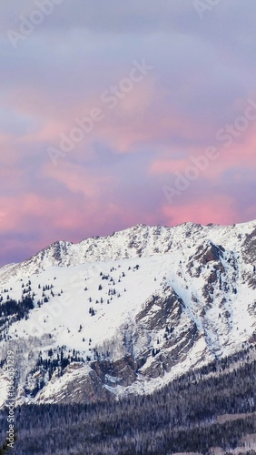 snow covered mountains in winter with cotton candy sunset