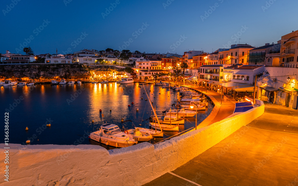 El Castell Menorca after sunset. View of the old port and the waterfront full of restaurants and pubs, city scape. Travel concept. Spain tourist attractions