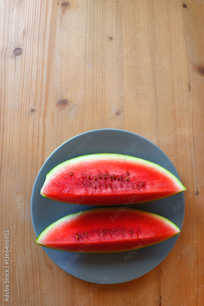 Plate with two watermelon slices on the table. Top view.