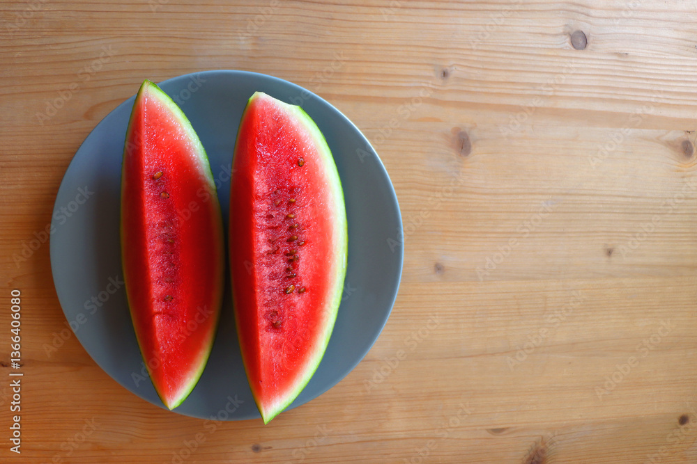 Plate with two watermelon slices on the table. Top view.