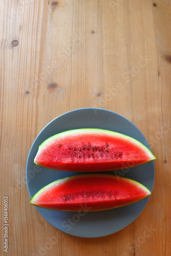 Obraz na płótnie Plate with two watermelon slices on the table. Top view. w salonie