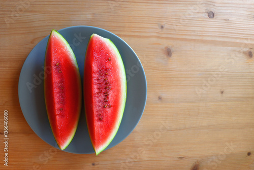 Obraz na płótnie Plate with two watermelon slices on the table. Top view. w salonie
