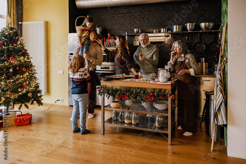 A White family spending quality time together in the kitchen during the holiday season, baking cookies, decorating, and enjoying the festive atmosphere around a Christmas tree with love and laughter.
