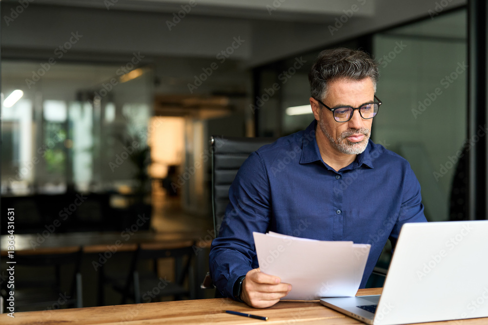 custom made wallpaper toronto digitalMiddle aged professional business man using laptop computer reading document at work. Busy mature male account bank manager executive working on laptop checking financial report in office. Copy space.