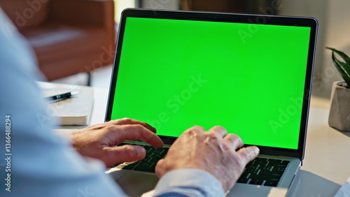 Obraz na płótnie Man hands typing greenscreen laptop apartment closeup. Remote manager working w salonie