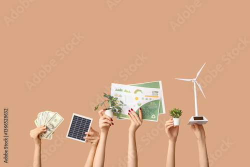 Many hands with wind turbin...