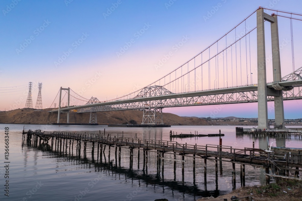Fototapeta premium The Alfred Zampa Memorial Bridge spans the Carquinez Strait in California, USA, connecting Contra Costa and Solano counties. An old pier sits in the foreground.