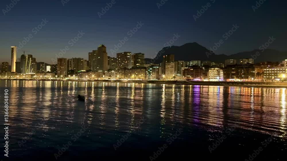 A breathtaking cityscape view at night showcasing a vibrant skyline along with shimmering reflections on water