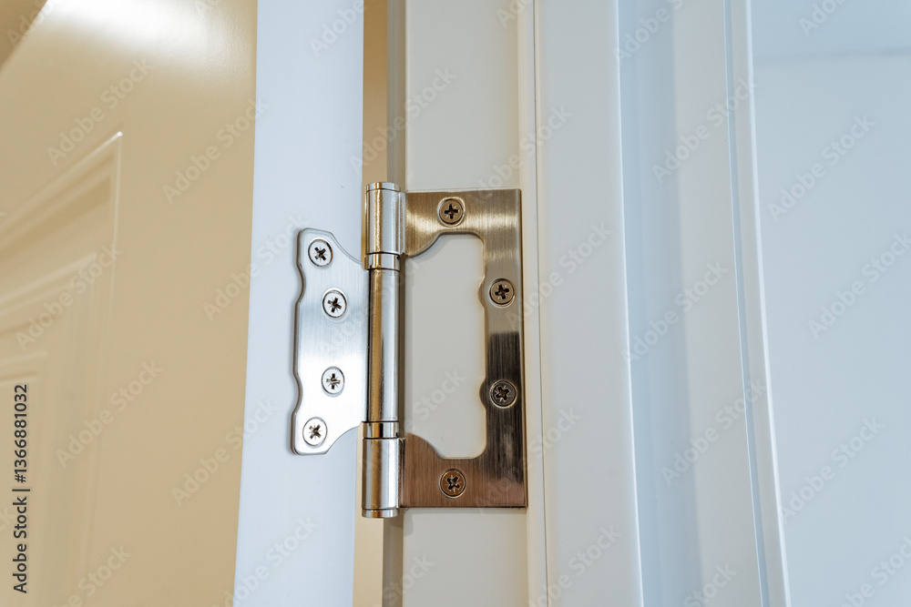 This is a detailed closeup image showcasing a door hinge installed on a sleek, white door, emphasizing the intricate design and functionality of the hardware that keeps doors secure This is a detailed closeup image showcasing a door hinge installed on a sleek, white door, emphasizing the intricate design and functionality of the hardware that keeps doors secure