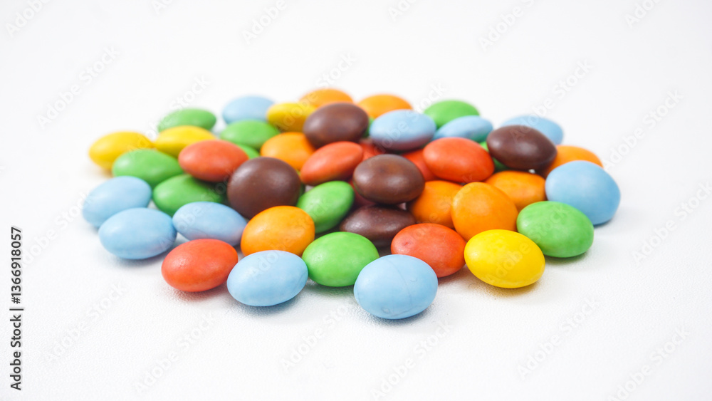 Vibrant sugar coated chocolate candies with a crunchy shell and chocolate filling isolated on white background Vibrant sugar coated chocolate candies with a crunchy shell and chocolate filling isolated on white background