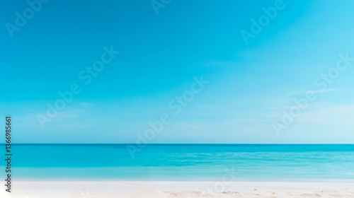 Wallpaper Mural A tranquil beach scene featuring a clear blue sky and calm turquoise waters meeting a soft sandy shore. Torontodigital.ca