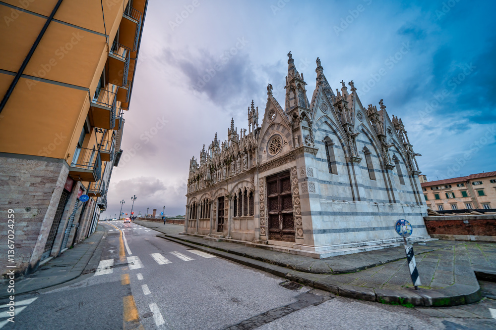 Scenic view of Chiesa della Spina in Pisa at dusk with vibrant sky and Arno reflections