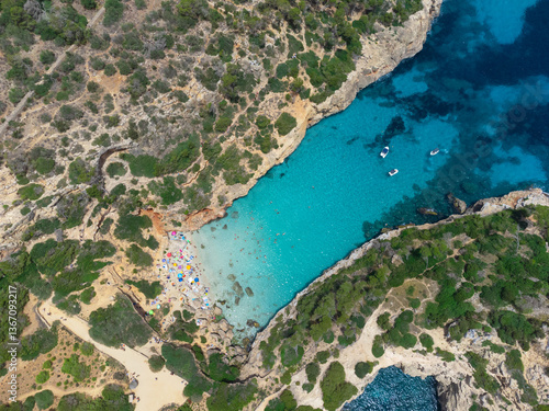 Aerial View of Calo Des Moro Beach with Turquoise Waters and Surrounding Cliffs in Mallorca