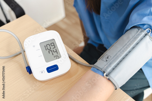 Fotografía Physical therapy, person is undergoing physical therapy while monitoring their blood pressure with digital device