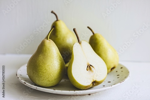 a few green pears on a white plate