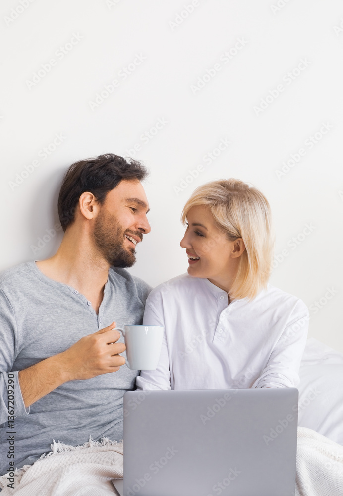 Internet technology, online shopping, e-commerce concept - happy smiling family, couple, middle aged man and woman, husband wife using laptop notebook in home bed room bedroom. Internet technology, online shopping, e-commerce concept - happy smiling family, couple, middle aged man and woman, husband wife using laptop notebook in home bed room bedroom.