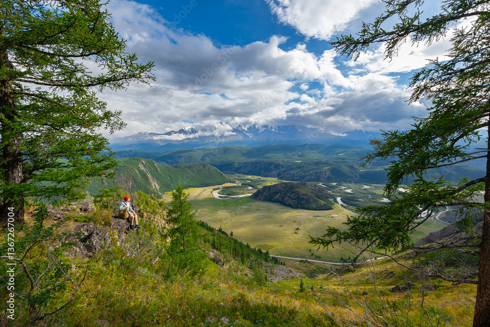 Fototapeta premium Hiker enjoying majestic Altay mountains and meandering river landscape, Russia
