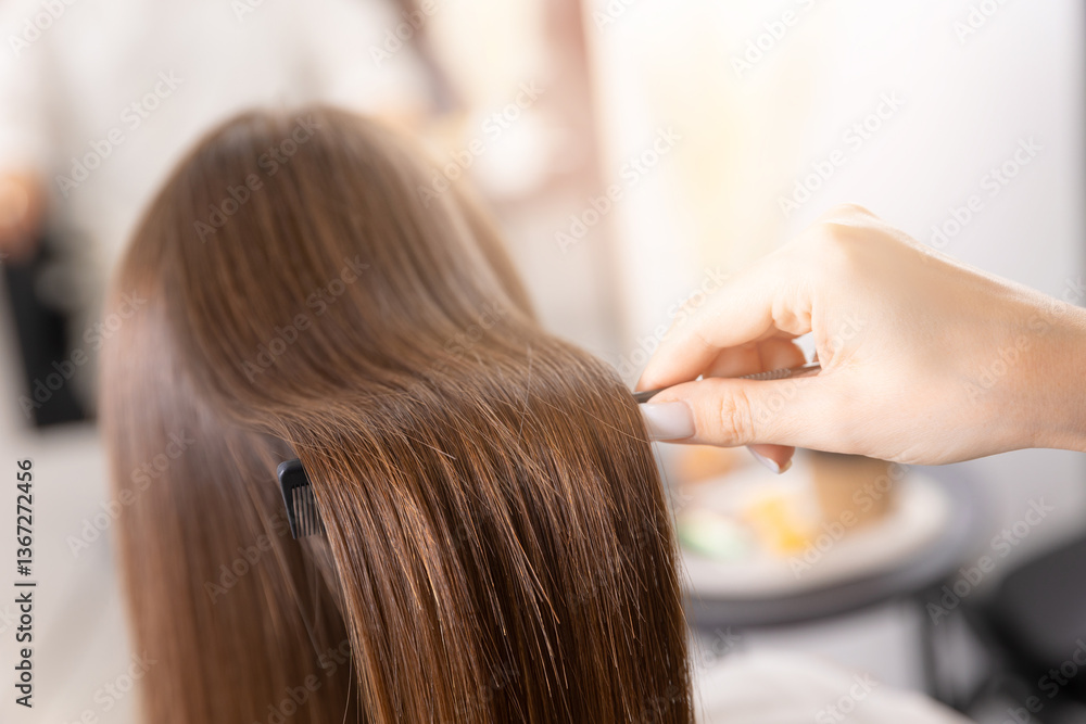 Fototapeta premium Professional hair care: female hair styling in modern salon setting