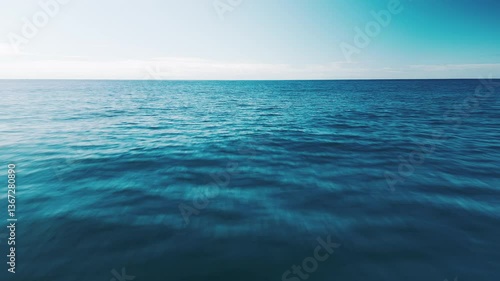 Low altitude flight over the sea. Camera flights fast over the ocean's surface with naturally blurred water surface.