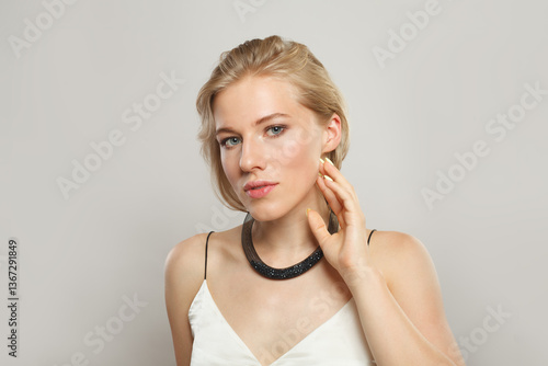 Good-looking smiling woman. Female model with blond hairstyle and clean skin, facial treatment, skin care and beauty concept