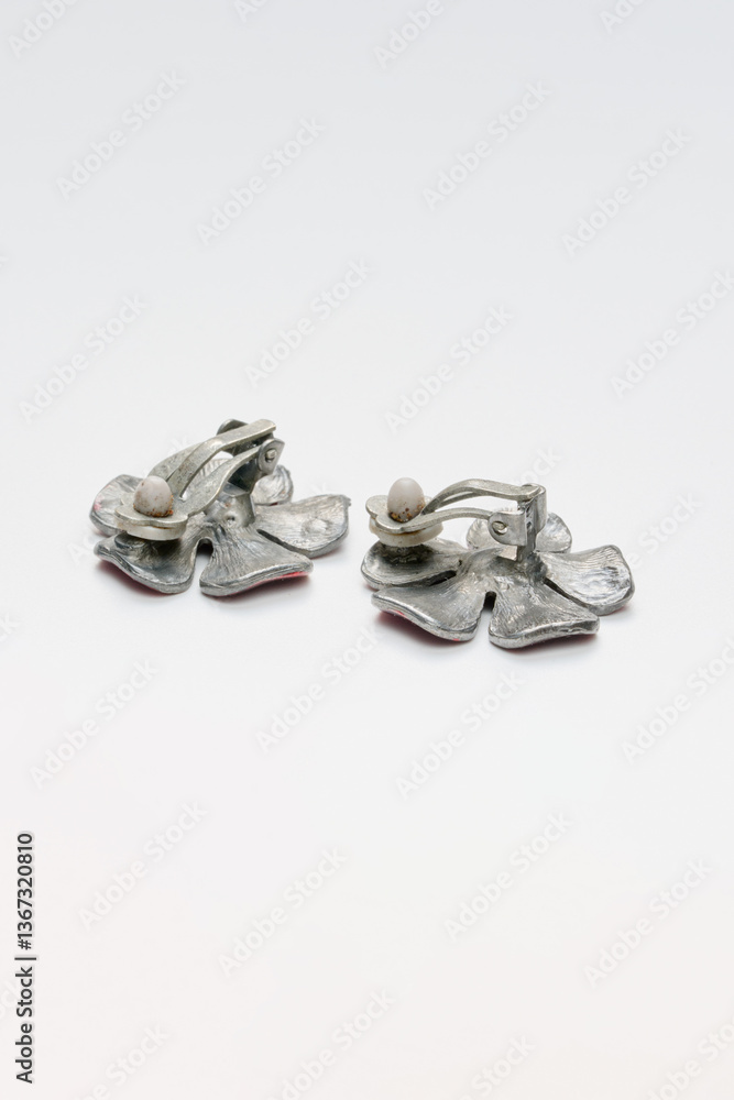Elegant Floral Enamel Earrings on Plain Background Elegant Floral Enamel Earrings on Plain Background