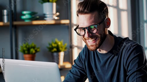 The Man Smiling at Laptop