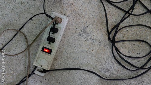 Canvas Print An old electrical outlet lying on the concrete floor
